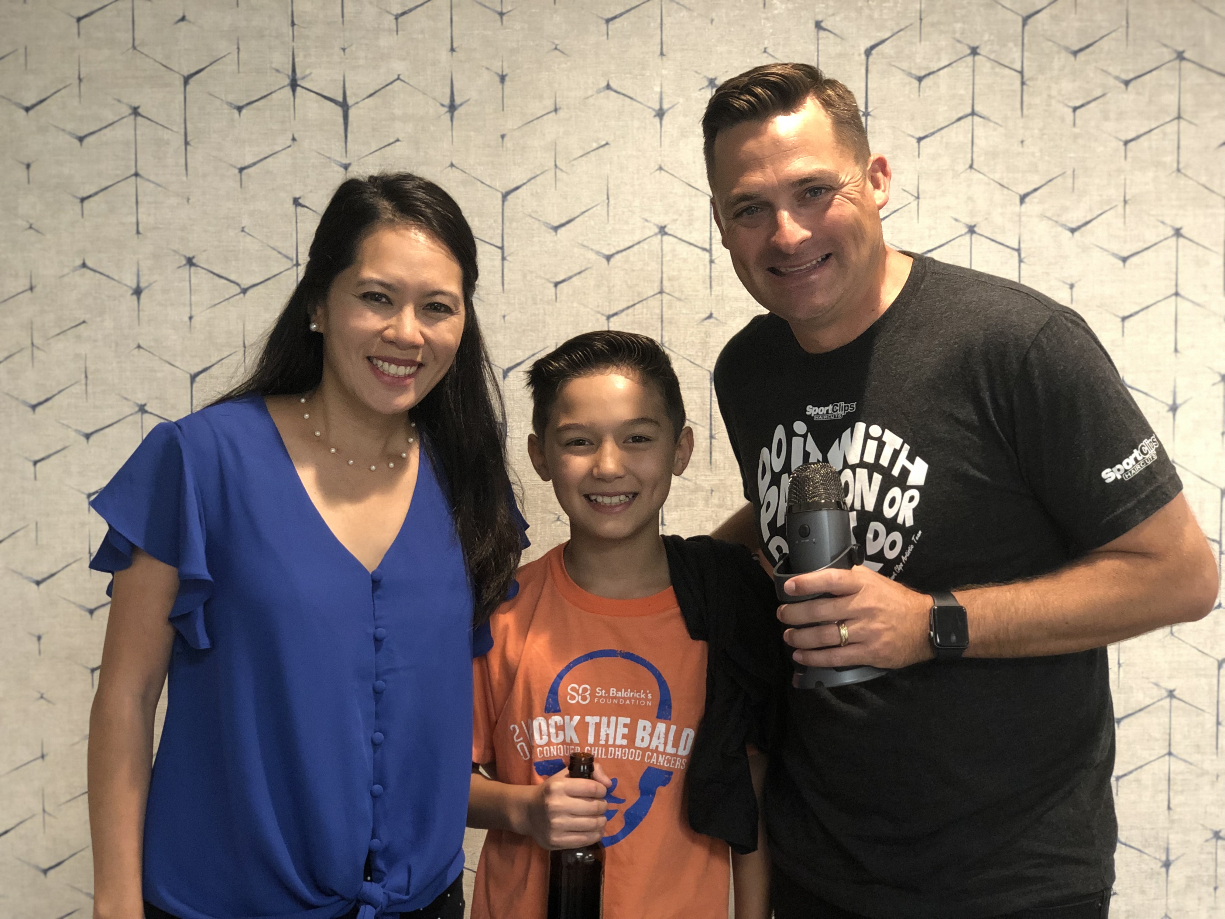 Chad Jordan with Scott holding a root beer and Nancy Lenfestey with microphone